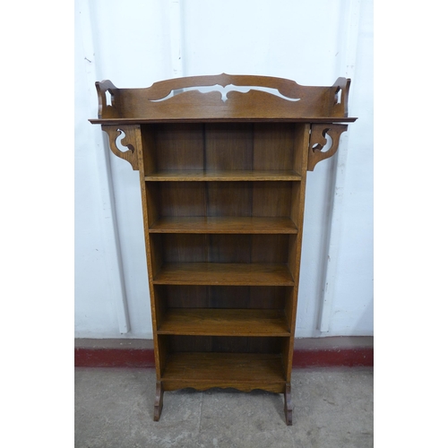 125A - An Arts and Crafts Liberty & Co. style oak open bookcase