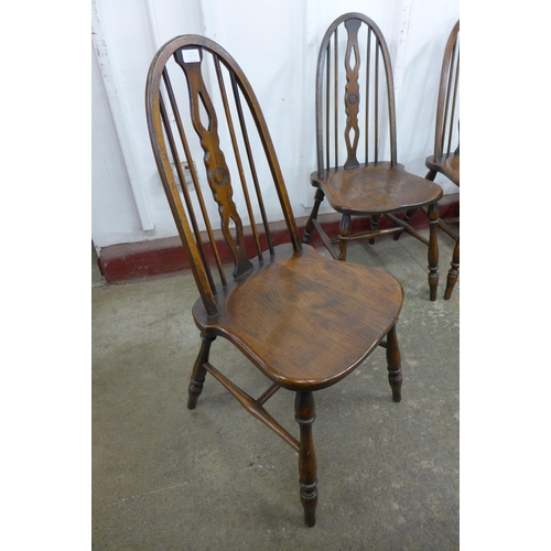 125D - A set of four elm and beech Windsor style kitchen chairs