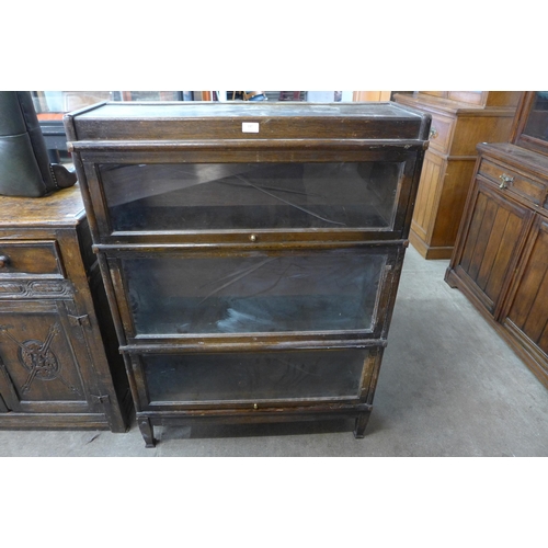 137 - An early 20th Century oak three tier sectional stacking bookcase