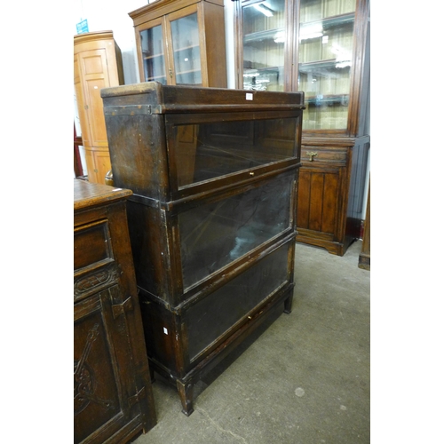 137 - An early 20th Century oak three tier sectional stacking bookcase