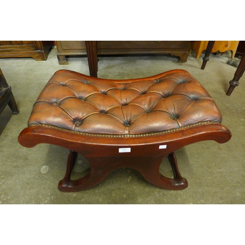 148 - A Regency style mahogany and chestnut brown leather x-frame footstool