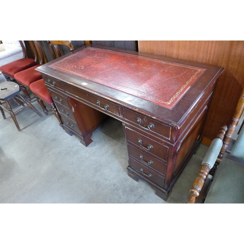 177 - A mahogany and red leather topped pedestal desk