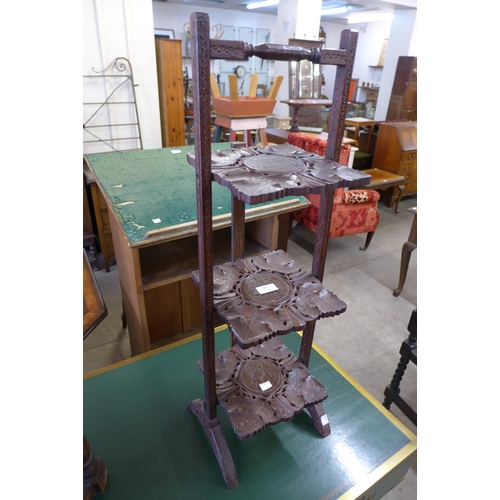 189 - An eastern carved softwood and brass inlaid folding cakestand