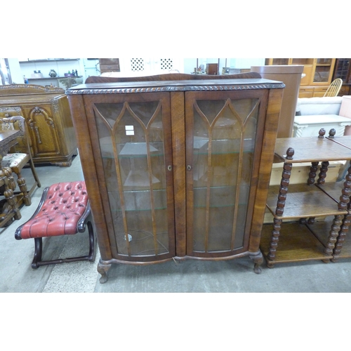 195 - A walnut serpentine two door display cabinet