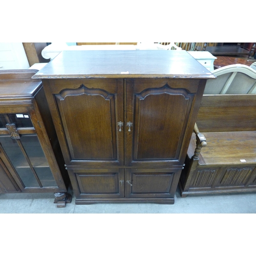 199 - A George III style Ipswich oak four door TV cabinet