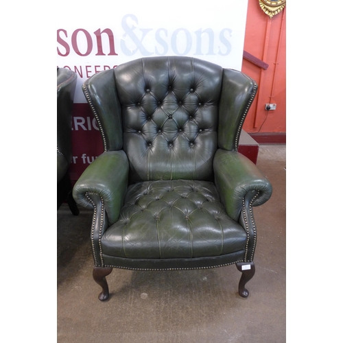 2 - A green leather Chesterfield wingback armchair