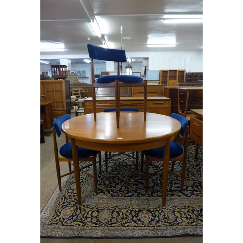 20 - A G-Plan Fresco teak circular extending dining table and four chairs