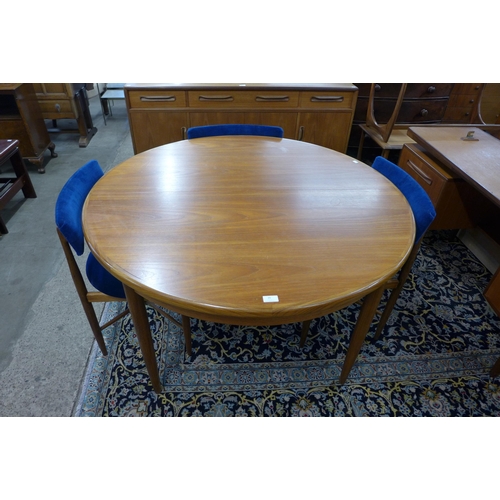 20 - A G-Plan Fresco teak circular extending dining table and four chairs