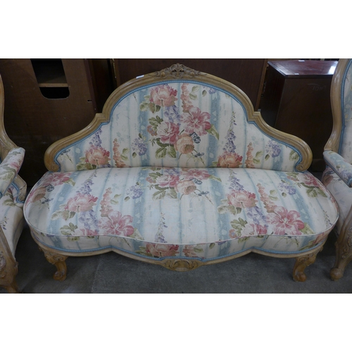 208 - A French Louis XV style carved walnut and fabric upholstered three piece salon suite, comprising; ca... 