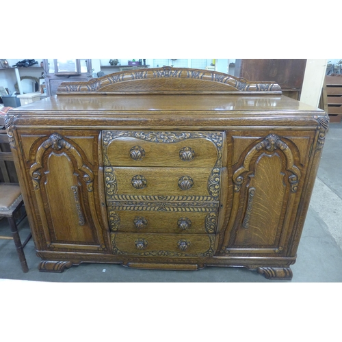 210 - An early 20th Century carved oak six piece dining suite, comprising; a draw-leaf table, four chairs ... 