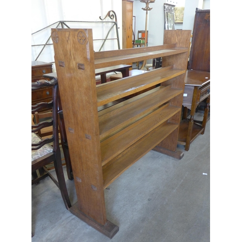 230 - A Gothic Revival carved oak open bookcase