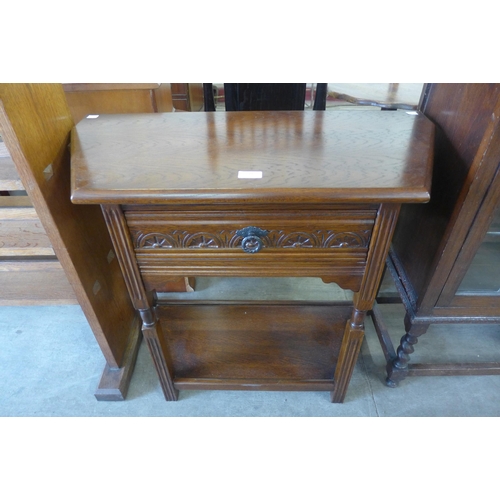 231 - A carved oak single drawer credence table