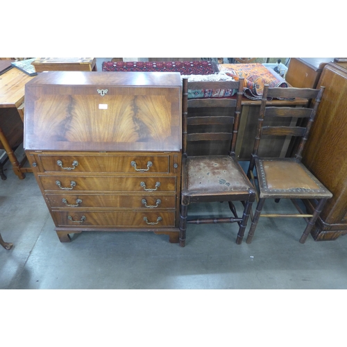 236 - A mahogany bureau and two oak chairs