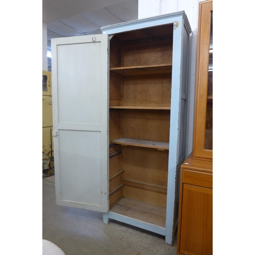 248 - An early 20th Century painted pine and ply wood single door housekeeper's cupboard