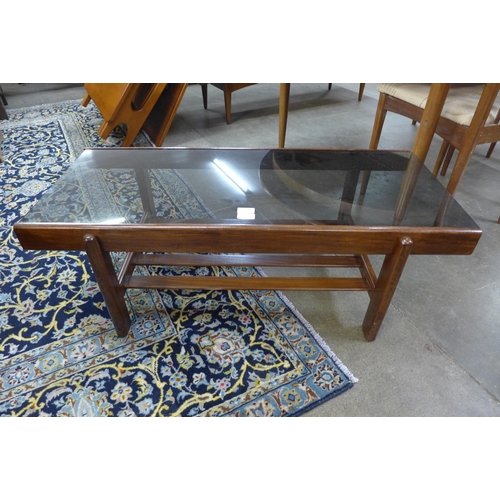 25 - A teak and glass topped rectangular coffee table