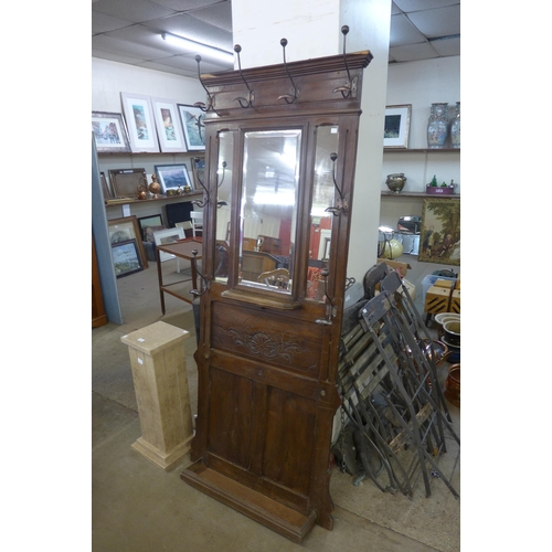 262 - An early 20th Century French carved beech mirrorback hallstand