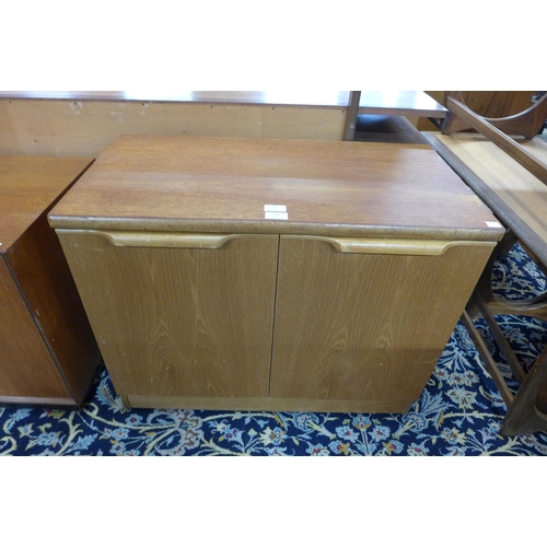 27 - A small Stonehill teak two door cupboard