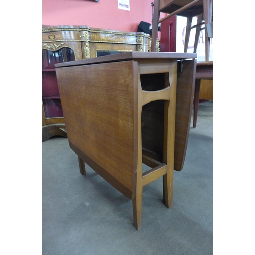 28 - A teak drop-leaf table