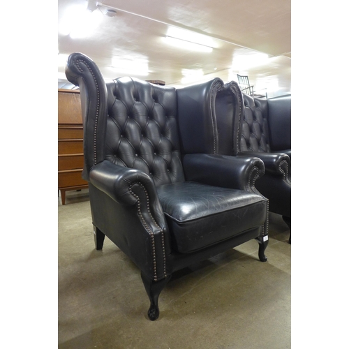 3 - A black leather Chesterfield Wingback armchair