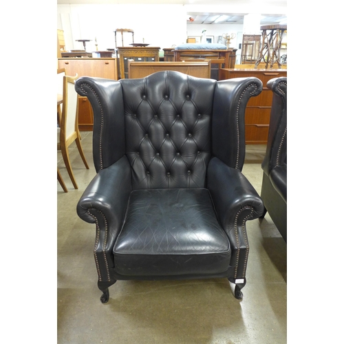 3 - A black leather Chesterfield Wingback armchair