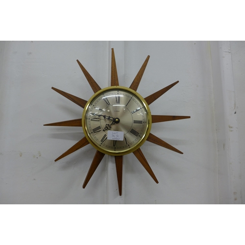 36G - A teak sunburst wall clock