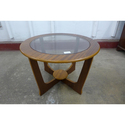 36J - A circular teak and glass topped coffee table