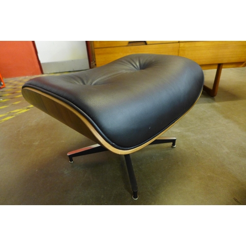 36W - A Charles & Ray Eames style simulated rosewood and black leather revolving lounge chair and ottoman