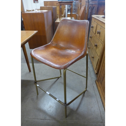 70 - A brown leather and steel framed bar stool