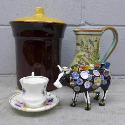 1150 - A Denby Glyn Colledge jug, foot a/f, a Rumtoft jar, a novelty cow figure, a/f, and a cup and saucer ... 