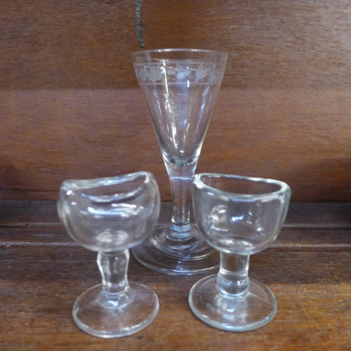 635B - An 18th Century wine glass and two eye baths