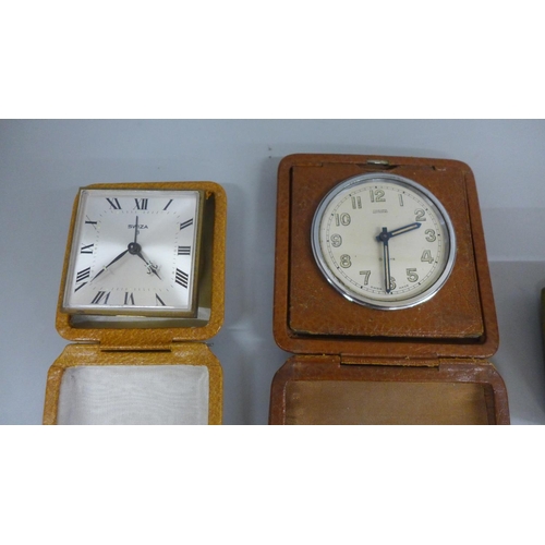 659 - Four small clocks including two Swiza and an 8 Days travel clock