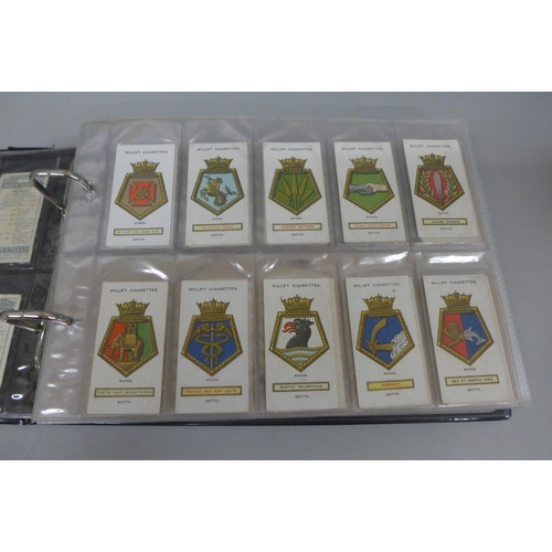 671 - Cigarette cards; an album containing ten complete sets of cigarette cards including Wills Ship's Bad... 