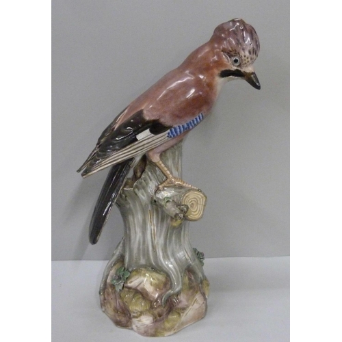 702 - A 19th Century Meissen model of a jay perched on a tree stump, wing tips a/f, 38cm