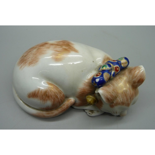 707 - A Japanese Taisho period Kutani porcelain model of a sleeping cat, 15.5cm