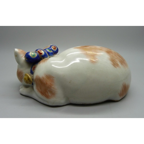 707 - A Japanese Taisho period Kutani porcelain model of a sleeping cat, 15.5cm