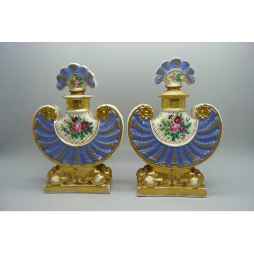 708 - A pair of 19th Century continental porcelain flasks, decorated with flowers against a gilt and blue ... 