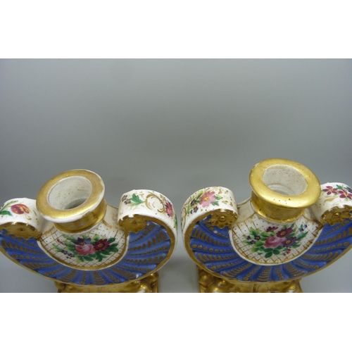 708 - A pair of 19th Century continental porcelain flasks, decorated with flowers against a gilt and blue ... 