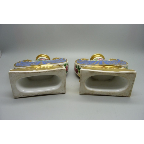 708 - A pair of 19th Century continental porcelain flasks, decorated with flowers against a gilt and blue ... 