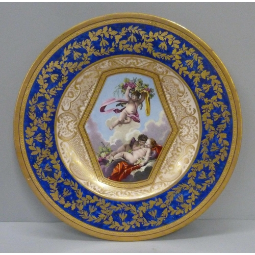 723 - A Sevres plate with bleu lapis and gilt border with the central reserve decorated with cherubs and g... 