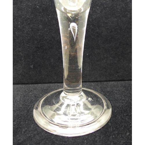 729 - An 18th Century heavy wine glass, circa 1740, with drawn trumpet bowl over a teared stem on a wide f... 