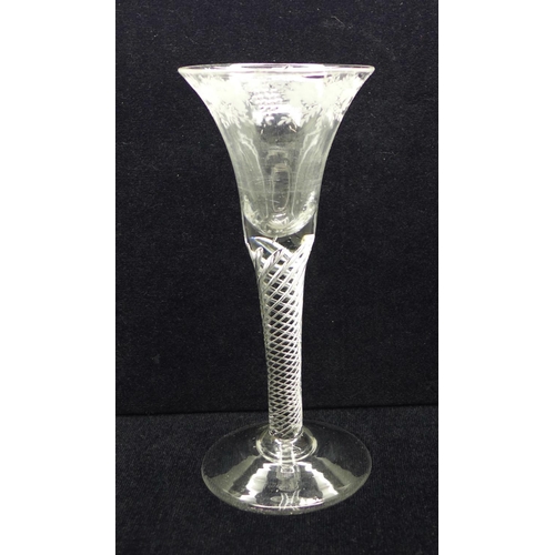 733 - An 18th Century wine glass having a bell bowl with an engraved frieze of vines and grapes over an ai... 