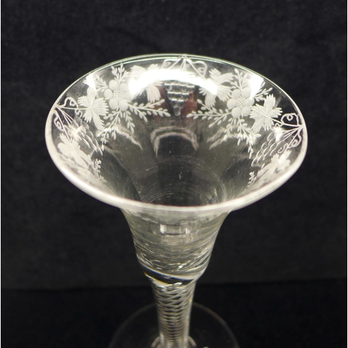 733 - An 18th Century wine glass having a bell bowl with an engraved frieze of vines and grapes over an ai... 