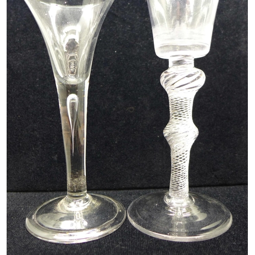 738 - An 18th Century wine glass having a bucket bowl with solid base over a double air twist knopped stem... 