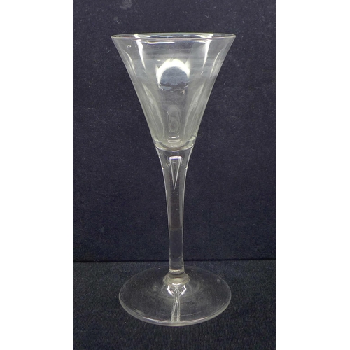 739 - An 18th Century toasting glass, circa 1750, with drawn trumpet bowl over a teared stem on a conical ... 