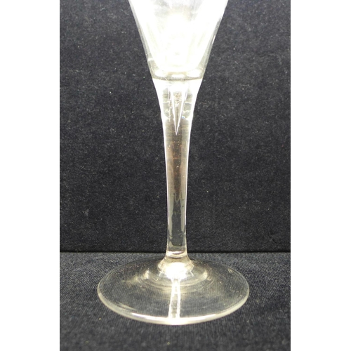 739 - An 18th Century toasting glass, circa 1750, with drawn trumpet bowl over a teared stem on a conical ... 