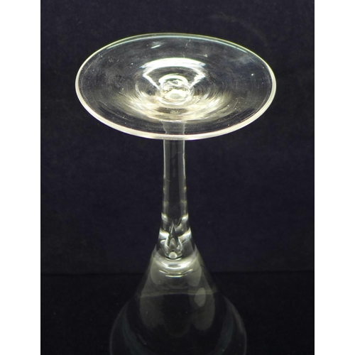 739 - An 18th Century toasting glass, circa 1750, with drawn trumpet bowl over a teared stem on a conical ... 