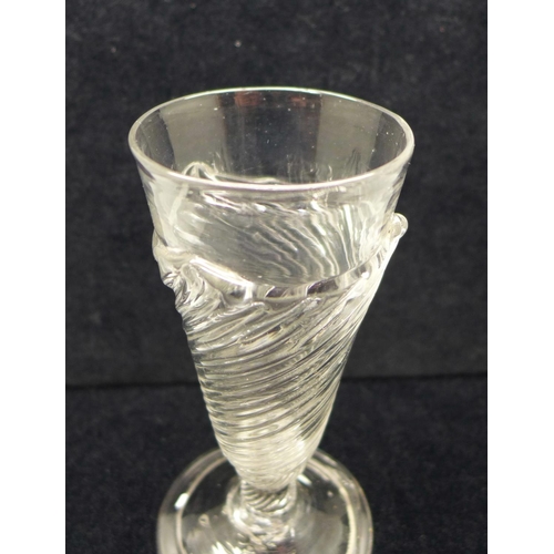 741 - An 18th Century dwarf ale glass, circa 1730, having wrythen funnel bowl with flammiform fringe on a ... 