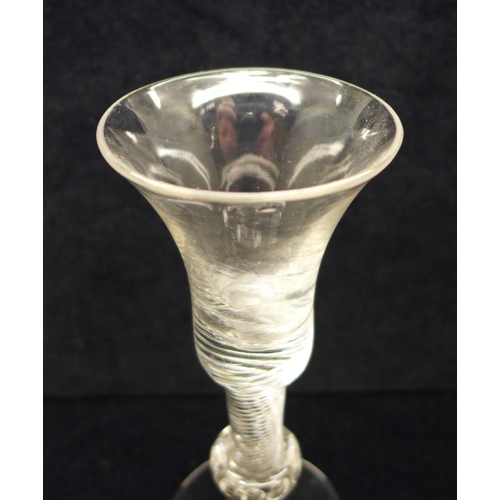 744 - An 18th Century composite wine glass having a bell bowl with solid base over an air twist stem with ... 