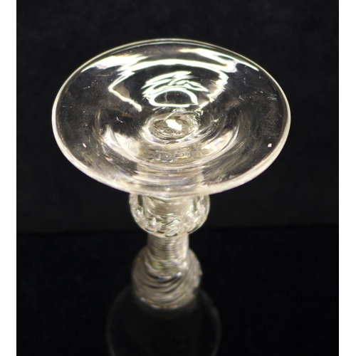 744 - An 18th Century composite wine glass having a bell bowl with solid base over an air twist stem with ... 