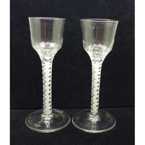 745 - A pair of 18th Century wine glasses, each with moulded ogee bowl over a double series open twist ste... 